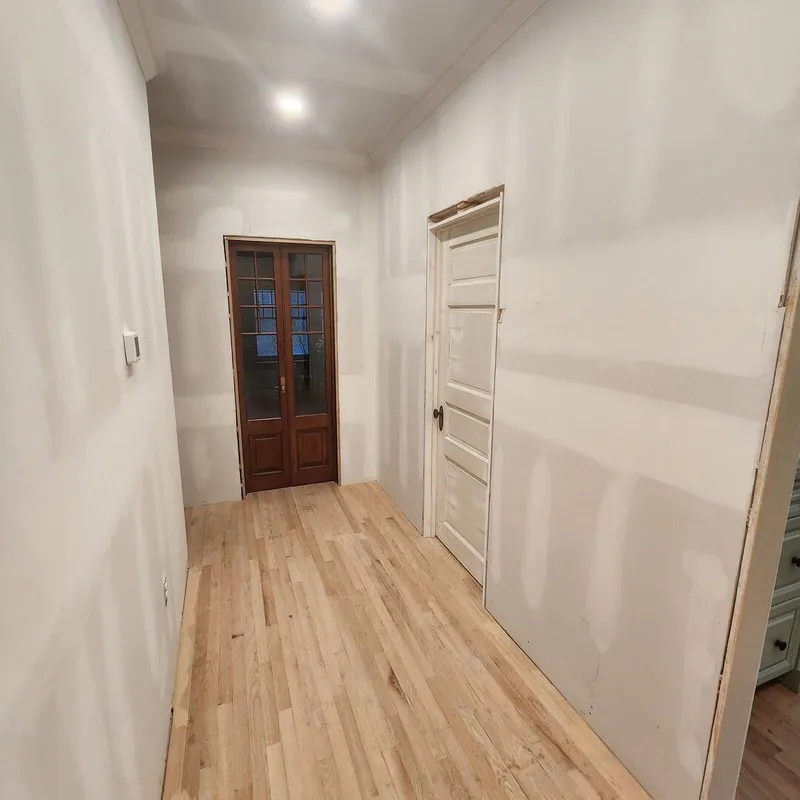 The first floor hallway coming together after installation of drywall and finish flooring.