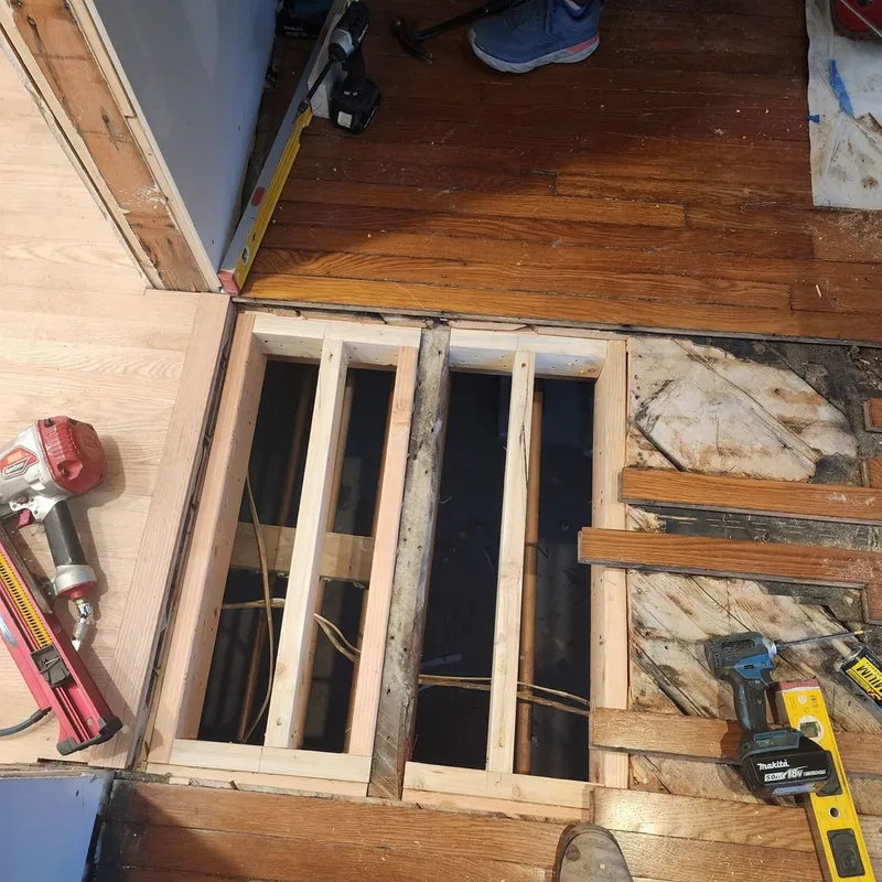 The area below the floor, newly reframed with healthy lumber.